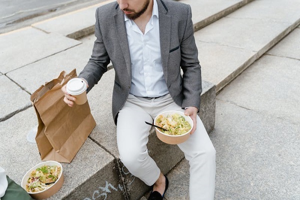 Man holding eco-friendly takeout containers.