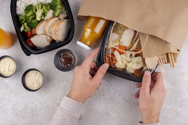 close up hands holding various kinds of food pack