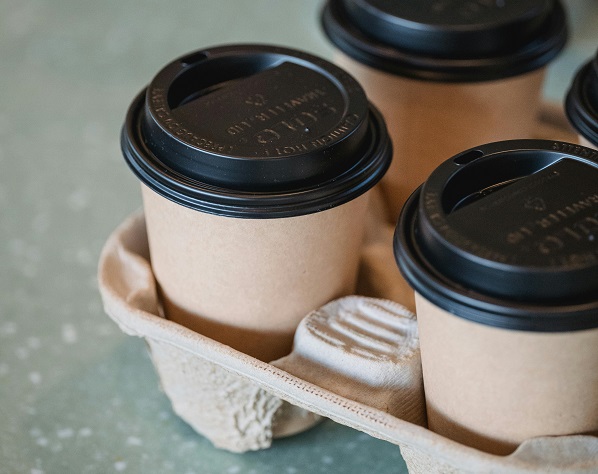 Disposable paper cup with black Sip-Through Lids.