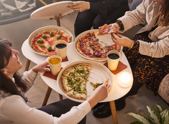 Eco-conscious customers enjoy takeaway pizzas packaged in bagasse boxes at home.