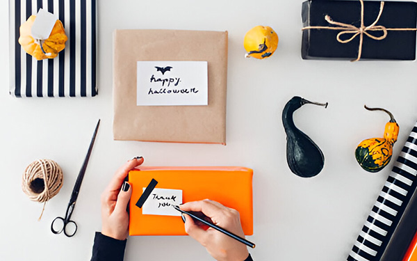 Women wrapping prodcuts in halloween theme