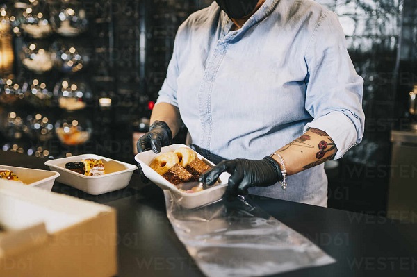 The chef distributes the food according to standardized portions of the menu.