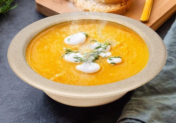 Pumpkin soup in a compostable sugarcane fiber bowl.